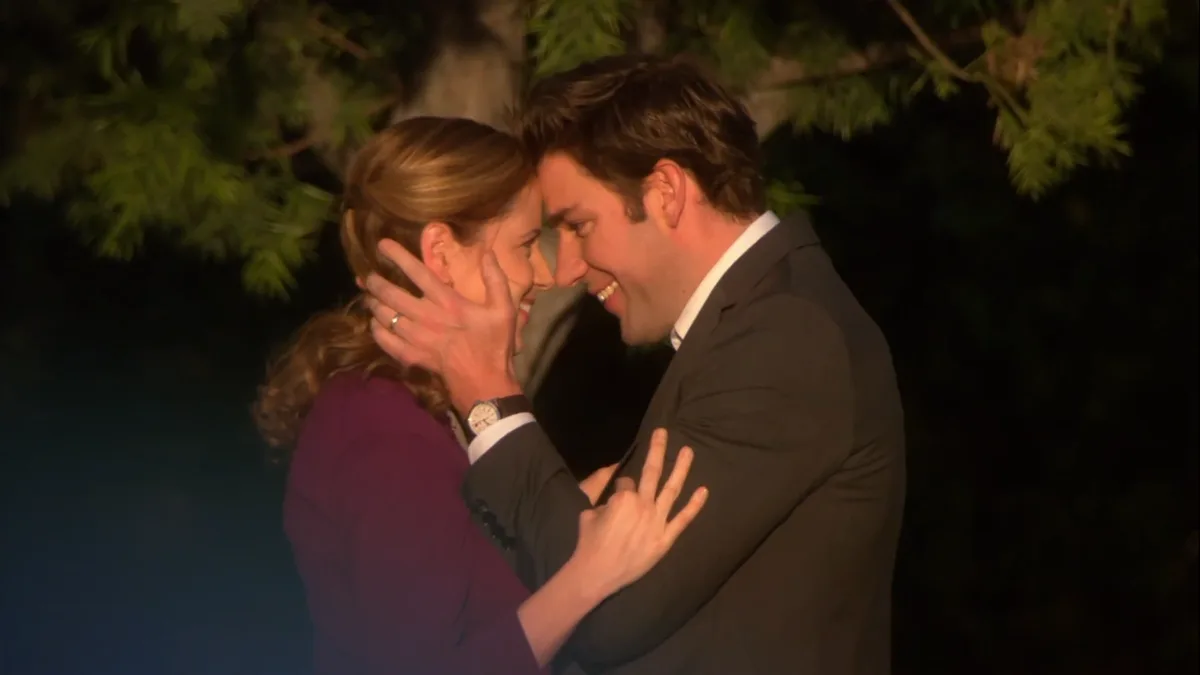 Jim and Pam from The Office smiling at each other.
